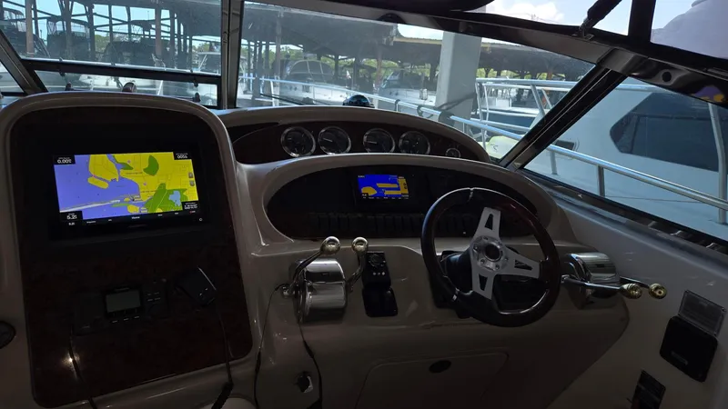 One More Time Yacht Photos Pics 2004 Sea Ray 380 Sundancer helm with navigation screens and steering wheel.