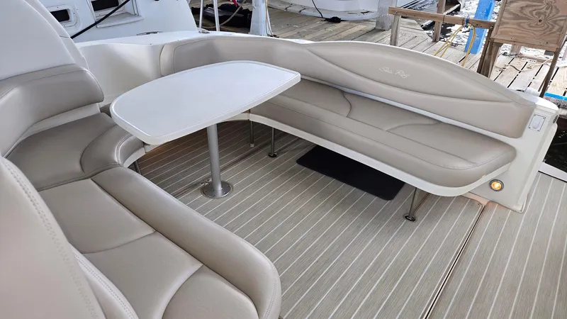 One More Time Yacht Photos Pics Luxurious seating area on 2004 Sea Ray 380 Sundancer yacht with beige upholstery and table.