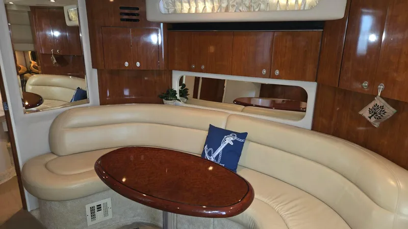 One More Time Yacht Photos Pics Luxurious interior of 2004 Sea Ray 380 Sundancer with elegant seating and wooden cabinetry.