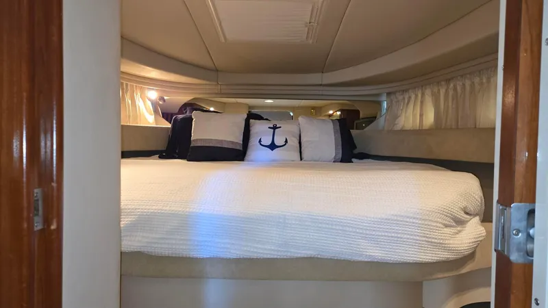 One More Time Yacht Photos Pics Interior cabin of 2004 Sea Ray 380 Sundancer with cozy bedding and nautical-themed pillows.
