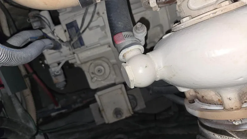 One More Time Yacht Photos Pics Engine compartment of a 2004 Sea Ray 380 Sundancer boat, showing hoses and mechanical components.