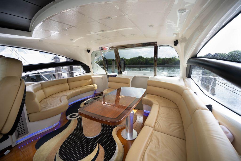 Luxurious interior of a 2007 Pershing 62' yacht with elegant seating and scenic views.