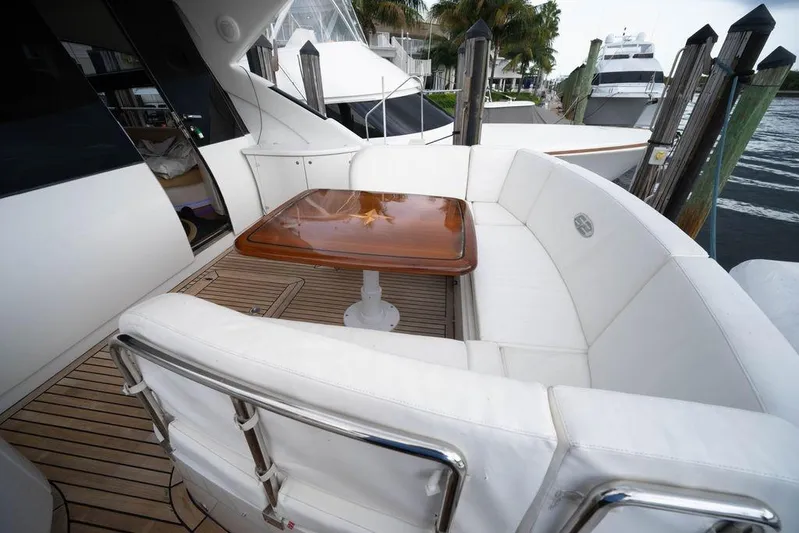Chopin Yacht Photos Pics Luxurious 2007 Pershing 62' yacht with elegant white seating and wooden table on deck.