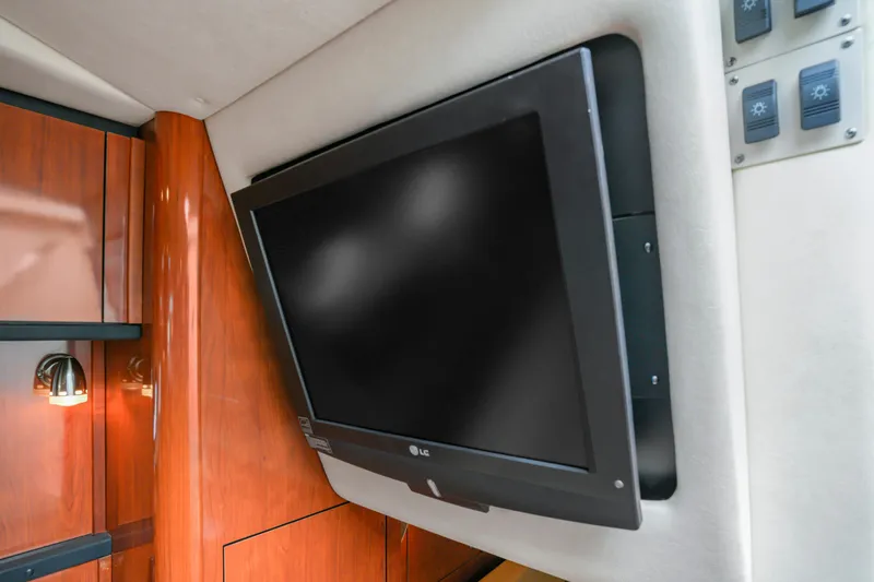 Beau Dacious Yacht Photos Pics Flat-screen TV in 2007 Sea Ray 310 Sundancer cabin with wood paneling.