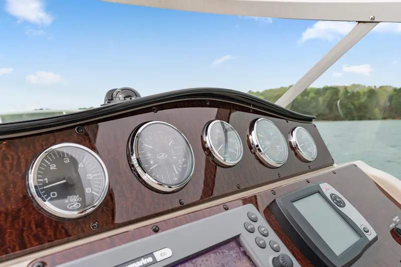Beau Dacious Yacht Photos Pics Dashboard of a 2007 Sea Ray 310 Sundancer boat with gauges and navigation equipment.