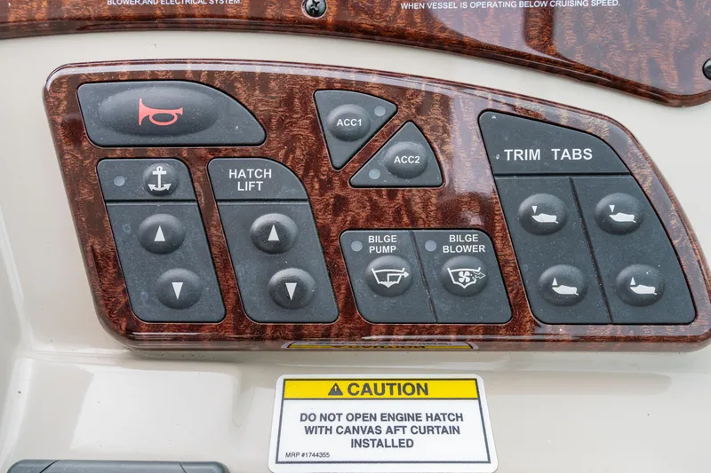 Beau Dacious Yacht Photos Pics Control panel of a 2007 Sea Ray 310 Sundancer with various switches and caution label.