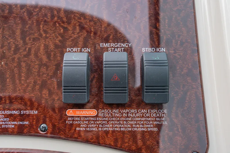 Beau Dacious Yacht Photos Pics Control panel of 2007 Sea Ray 310 Sundancer with ignition switches and safety warning.