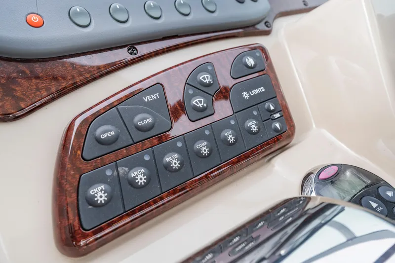 Beau Dacious Yacht Photos Pics Control panel of a 2007 Sea Ray 310 Sundancer boat with various switches.