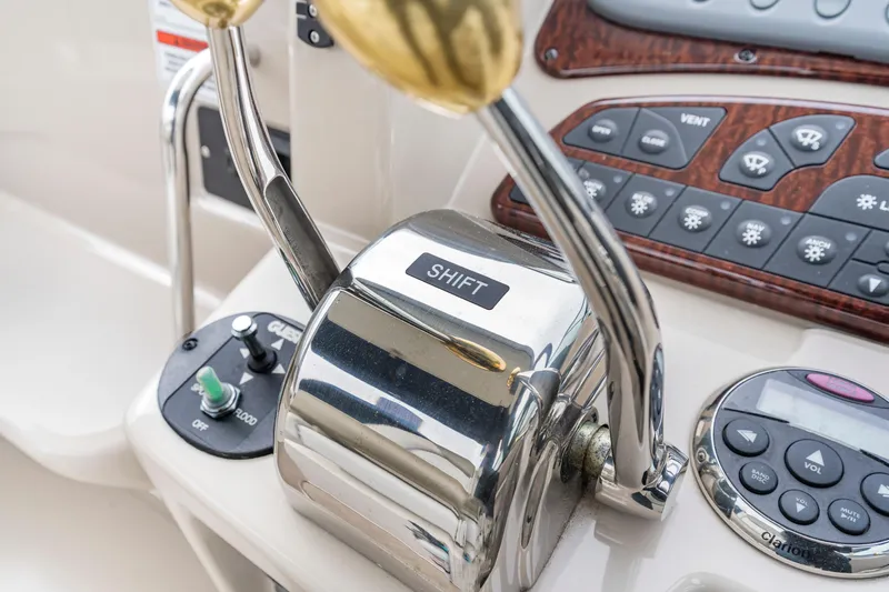 Beau Dacious Yacht Photos Pics Control panel of 2007 Sea Ray 310 Sundancer boat with shift lever and buttons.