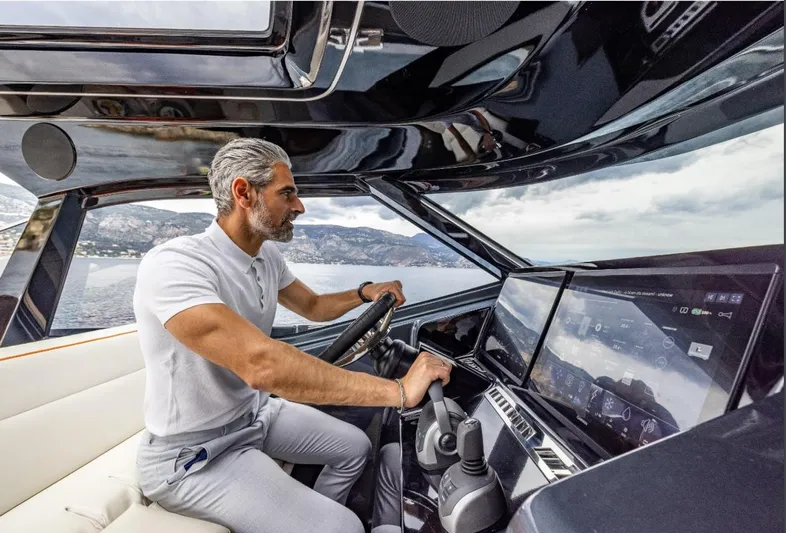  Yacht Photos Pics Man piloting 2026 Bekkers Yachts Azur 45, modern dashboard, ocean view.