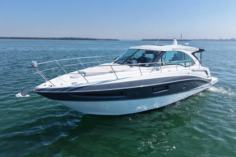  Yacht Photos Pics 2018 Cruisers Yachts 41 Cantius cruising on calm waters under a clear blue sky.