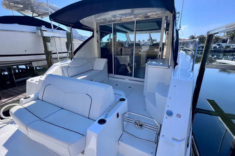  Yacht Photos Pics 2018 Cruisers Yachts 41 Cantius with sleek seating and modern design at a marina.