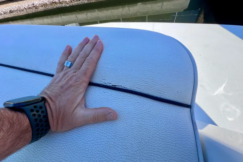  Yacht Photos Pics Hand inspecting cracked upholstery on 2018 Cruisers Yachts 41 Cantius boat seat.