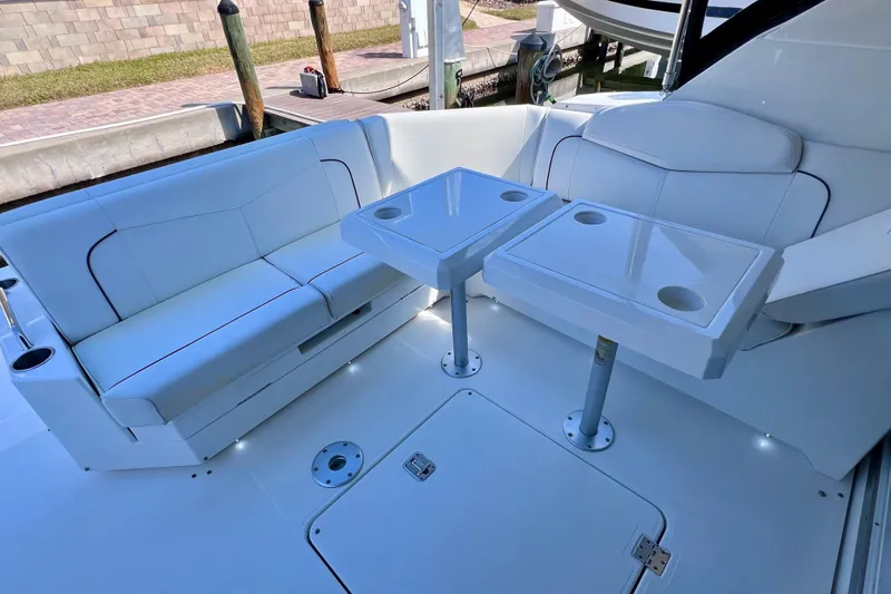  Yacht Photos Pics 2018 Cruisers Yachts 41 Cantius cockpit with white seating and dual tables.