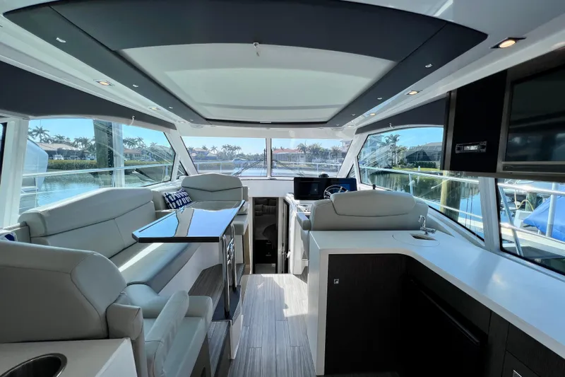  Yacht Photos Pics Luxurious interior of 2018 Cruisers Yachts 41 Cantius with modern seating and panoramic windows.