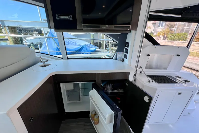  Yacht Photos Pics 2018 Cruisers Yachts 41 Cantius interior kitchen with sink, fridge, and grill.