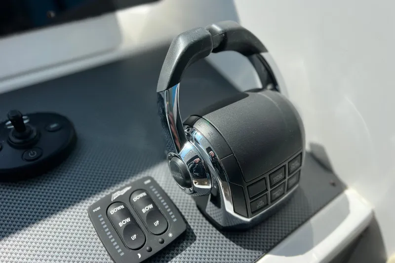  Yacht Photos Pics Throttle controls on 2018 Cruisers Yachts 41 Cantius dashboard, featuring joystick and trim buttons.