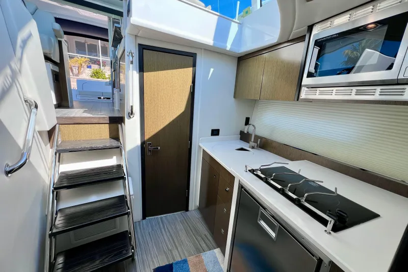  Yacht Photos Pics Modern kitchen interior of 2018 Cruisers Yachts 41 Cantius with sleek design and appliances.