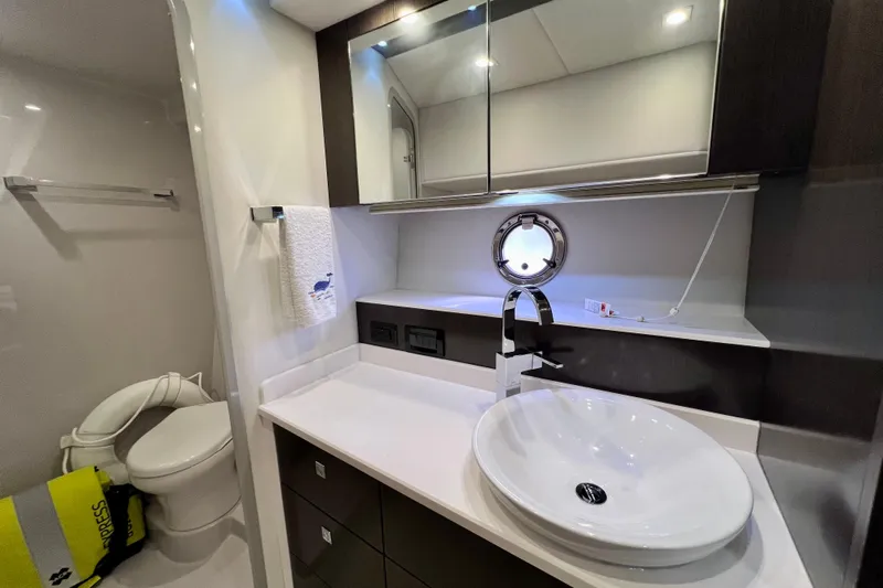  Yacht Photos Pics Luxurious bathroom in 2018 Cruisers Yachts 41 Cantius, featuring modern sink and porthole window.