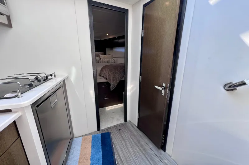  Yacht Photos Pics 2018 Cruisers Yachts 41 Cantius interior with kitchenette and bedroom view.