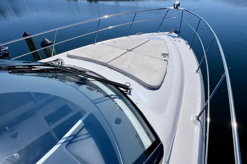  Yacht Photos Pics 2018 Cruisers Yachts 41 Cantius bow view with sunpad and railing on calm water.