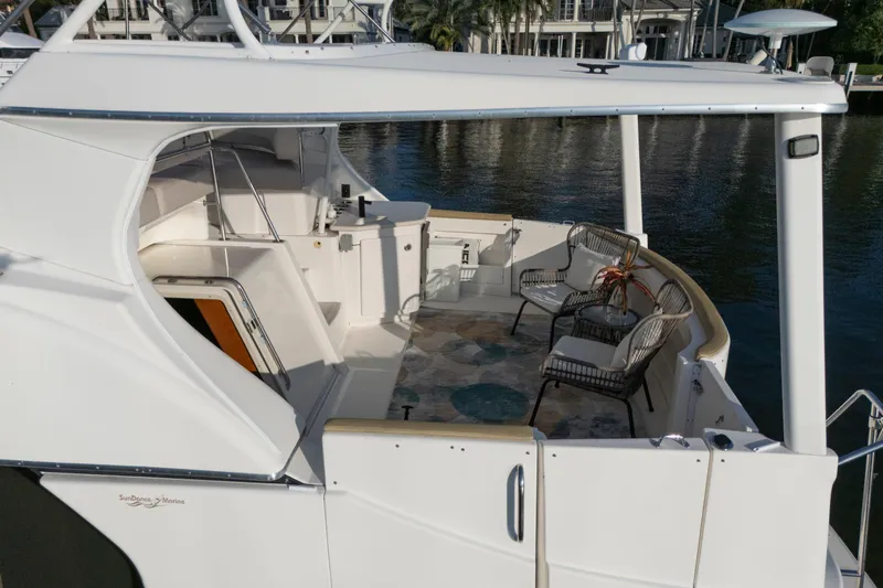 Good Medicine Yacht Photos Pics 2004 Silverton 43 Motor Yacht with spacious deck and seating area by the water.