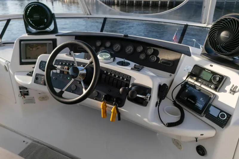 Good Medicine Yacht Photos Pics 2004 Silverton 43 Motor Yacht helm with steering wheel, gauges, and navigation equipment.
