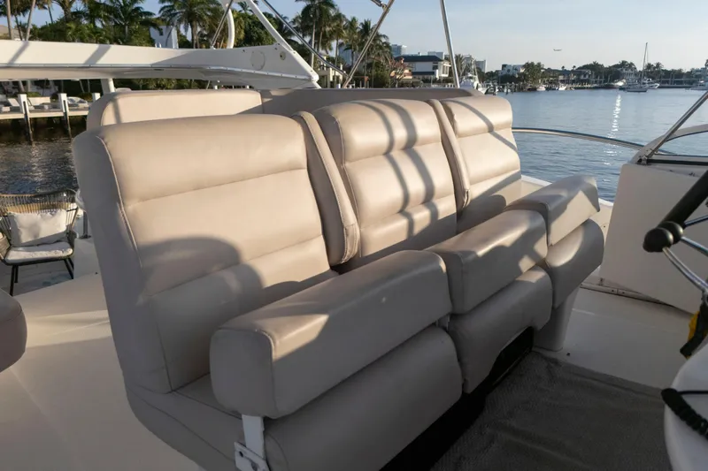 Good Medicine Yacht Photos Pics 2004 Silverton 43 Motor Yacht interior with beige seating, overlooking a serene waterfront.