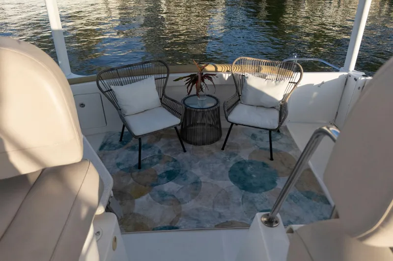 Good Medicine Yacht Photos Pics 2004 Silverton 43 Motor Yacht deck with chairs and table, overlooking water.