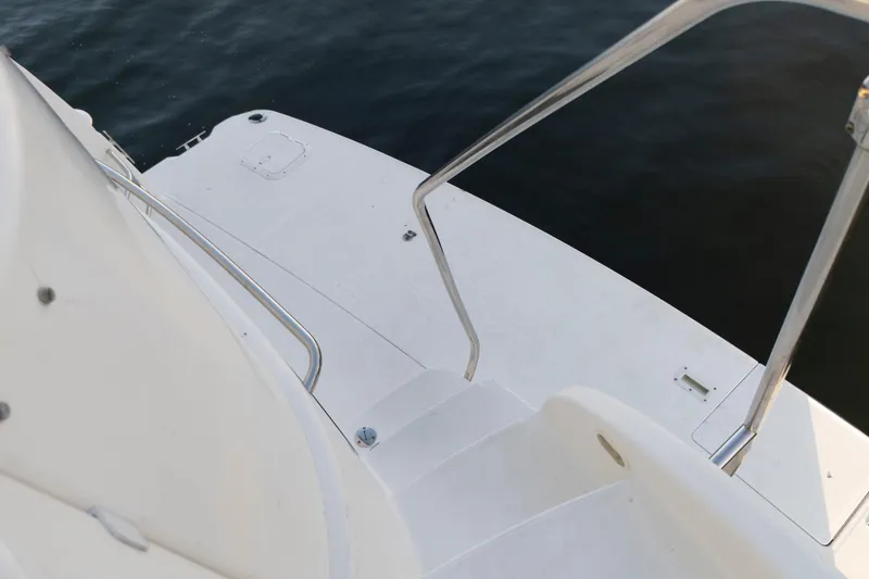 Good Medicine Yacht Photos Pics 2004 Silverton 43 Motor Yacht deck with railing, overlooking calm water.