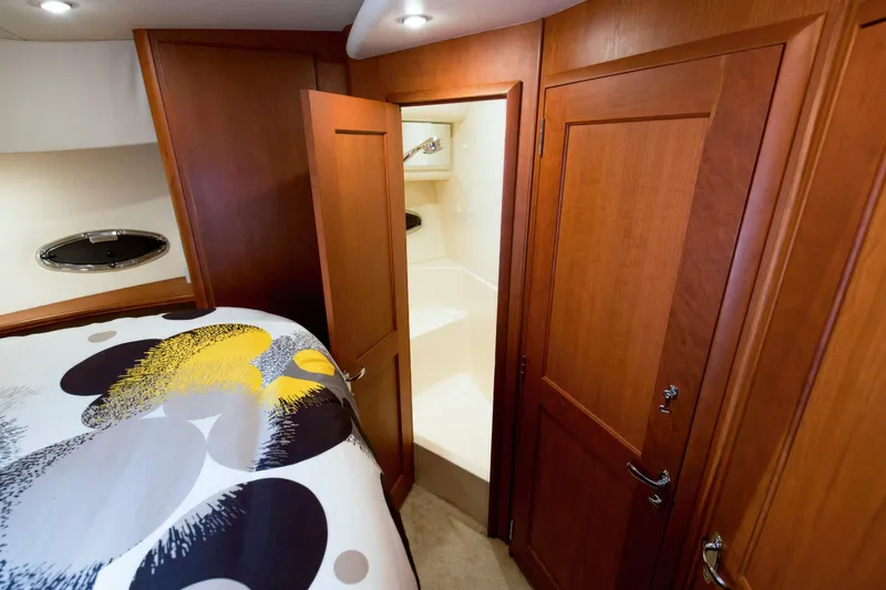 Good Medicine Yacht Photos Pics 2004 Silverton 43 Motor Yacht bedroom with modern bedding and wooden cabinetry.