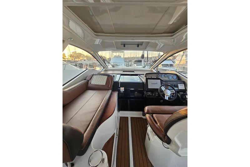 Levon II Yacht Photos Pics 2017 Sea Ray Sundancer 350 Coupe interior with leather seating and modern dashboard.