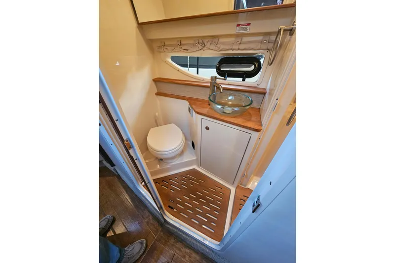 Levon II Yacht Photos Pics 2017 Sea Ray Sundancer 350 Coupe bathroom with modern sink and wooden accents.