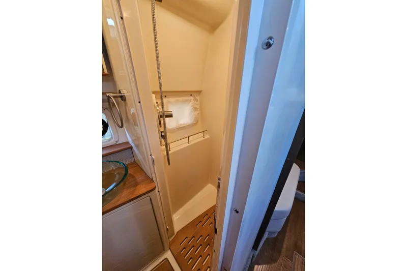 Levon II Yacht Photos Pics 2017 Sea Ray Sundancer 350 Coupe shower area with wooden flooring and modern fixtures.