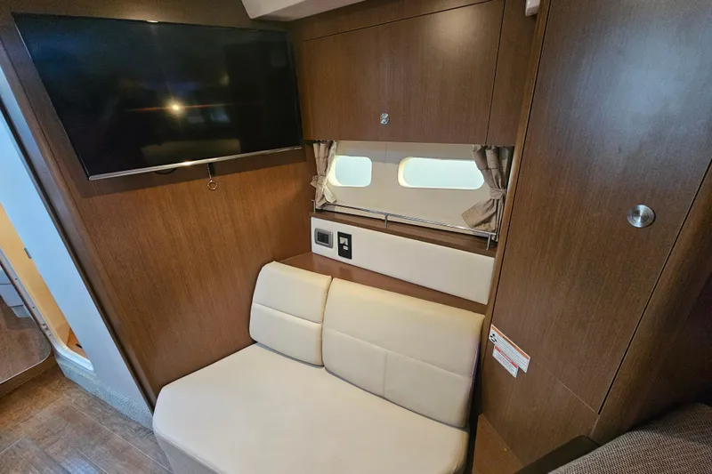 Levon II Yacht Photos Pics 2017 Sea Ray Sundancer 350 Coupe interior with TV, seating, and window.