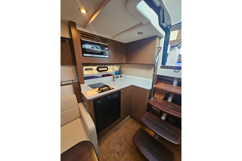 Levon II Yacht Photos Pics 2017 Sea Ray Sundancer 350 Coupe interior kitchen with modern appliances and wooden cabinetry.