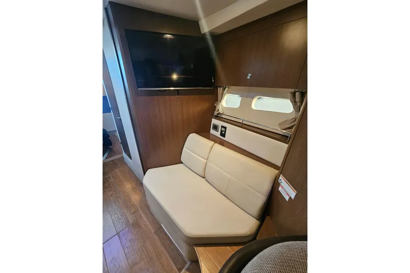 Levon II Yacht Photos Pics Interior of 2017 Sea Ray Sundancer 350 Coupe with TV and seating area.