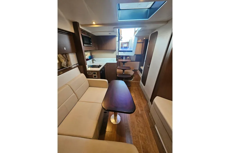 Levon II Yacht Photos Pics Luxurious interior of 2017 Sea Ray Sundancer 350 Coupe with modern kitchen and seating area.