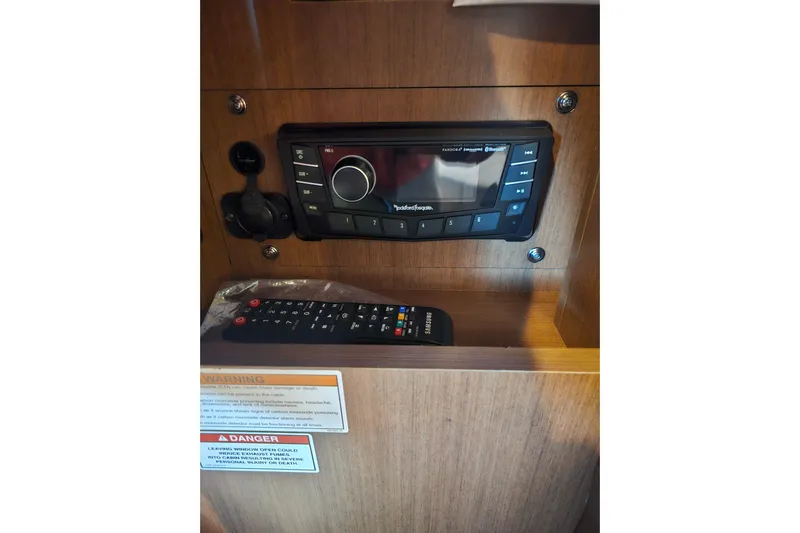 Levon II Yacht Photos Pics 2017 Sea Ray Sundancer 350 Coupe audio system with remote control in wooden cabinet.
