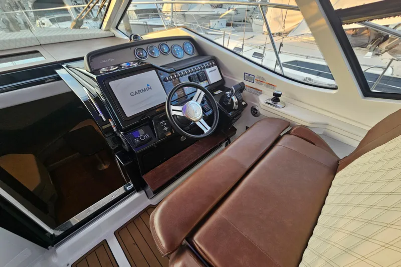Levon II Yacht Photos Pics 2017 Sea Ray Sundancer 350 Coupe helm with Garmin navigation, leather seating, and modern controls.
