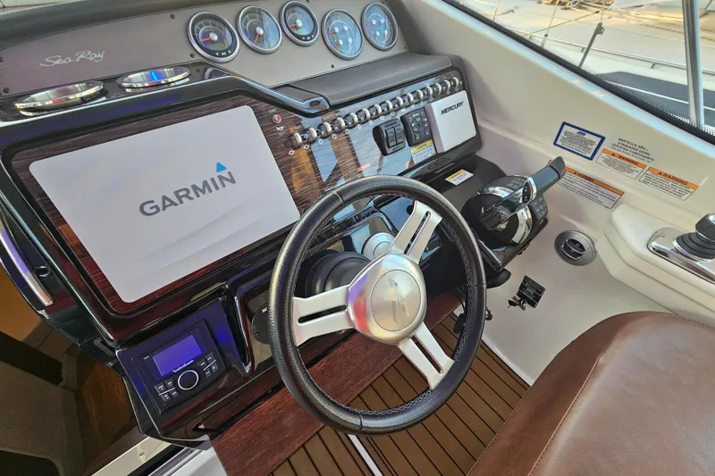 Levon II Yacht Photos Pics 2017 Sea Ray Sundancer 350 Coupe helm with Garmin navigation and Mercury controls.