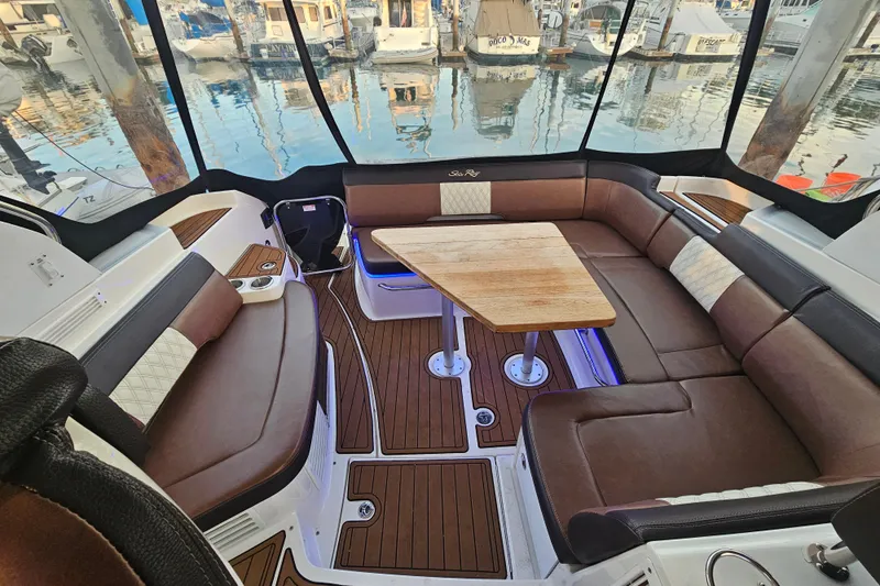 Levon II Yacht Photos Pics Luxurious interior of 2017 Sea Ray Sundancer 350 Coupe with elegant seating and wooden table.