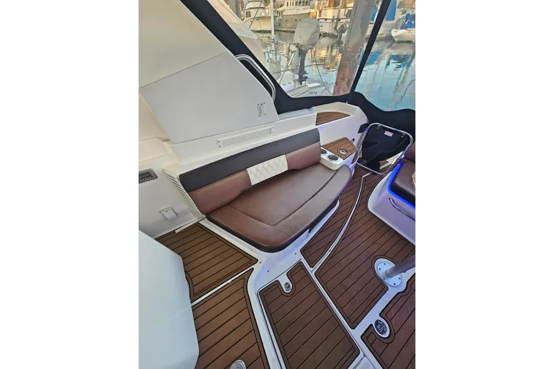 Levon II Yacht Photos Pics 2017 Sea Ray Sundancer 350 Coupe interior with brown seating and wood flooring.