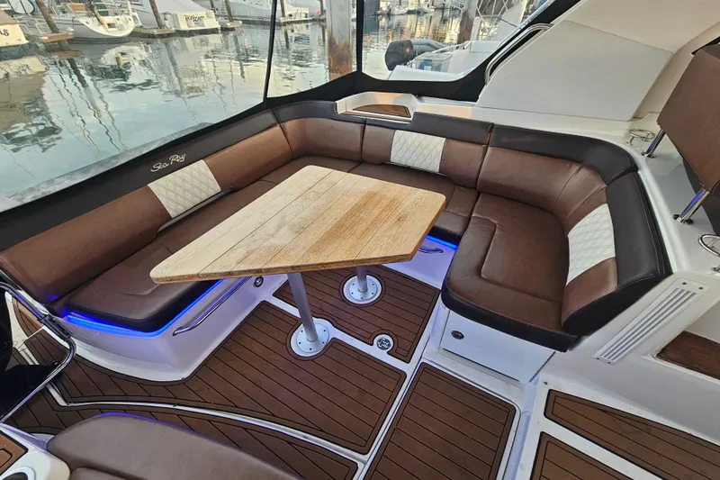 Levon II Yacht Photos Pics Luxurious 2017 Sea Ray Sundancer 350 Coupe interior with elegant seating and wooden table.