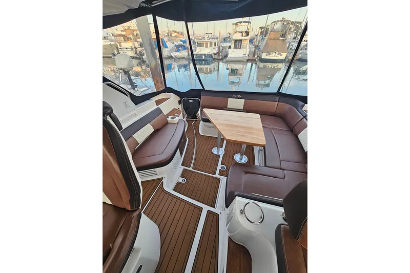 Levon II Yacht Photos Pics Luxurious 2017 Sea Ray Sundancer 350 Coupe interior with elegant seating and wooden table.
