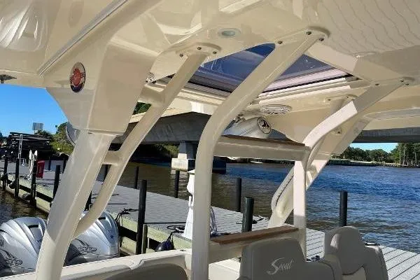  Yacht Photos Pics 2019 Scout 380 LXF boat interior with sleek design, docked by a scenic waterfront.