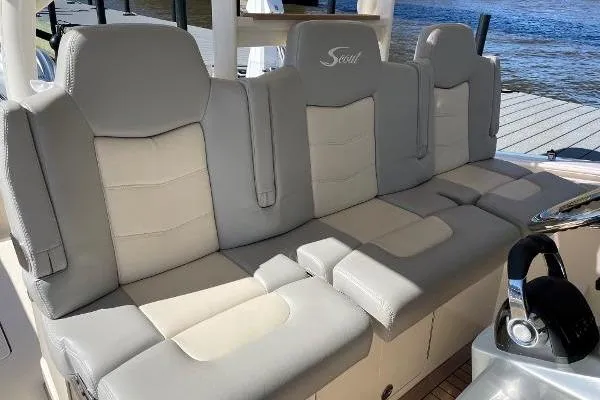  Yacht Photos Pics 2019 Scout 380 LXF boat seating with gray and beige upholstery, dockside view.