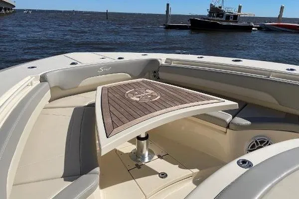  Yacht Photos Pics 2019 Scout 380 LXF boat interior with elegant seating and wooden table on the water.