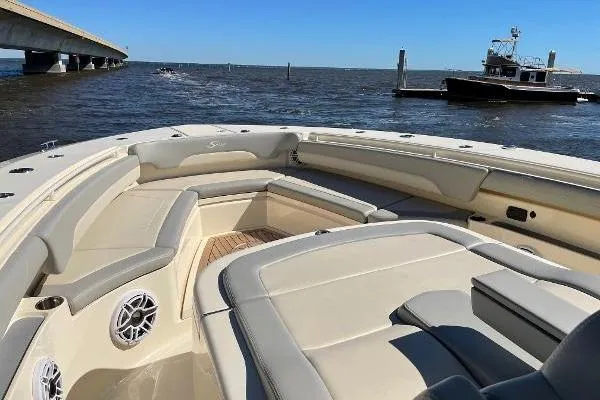  Yacht Photos Pics 2019 Scout 380 LXF boat with spacious seating, cruising on open water near a bridge.