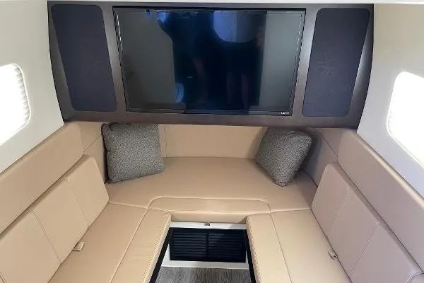  Yacht Photos Pics Luxurious interior of 2019 Scout 380 LXF with beige seating and a flat-screen TV.